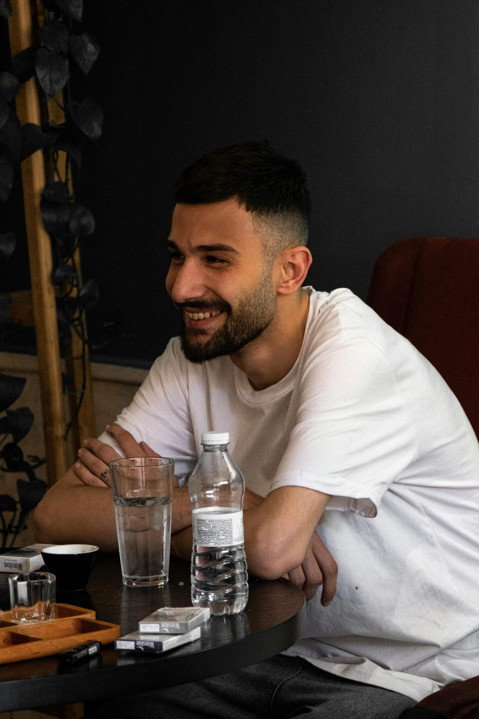 pexels-photo-29154496-29154496 Young man enjoying a relaxed moment at a café in Tabriz, Iran. Warm and inviting atmosphere.